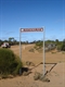 Sign By Bend in Road at the Rock.