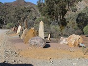 Large geological specimens lining entry to village