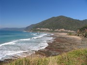 The Great Ocean Rd cuts around the mountain.