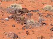 Many old bottles and cans at the camp site at Base A