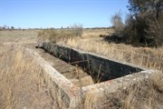 Channellled water runs into a pipeline that feeds the concrete