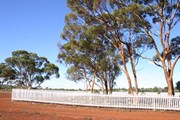 Cemetery enclosed within white picket fence