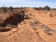 Very large open cut pit on the side of the shot line