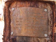 Plaque on tree at the pool.