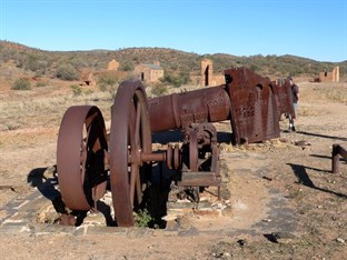 Old mining machinery and partially restored buildings at Arltunga
