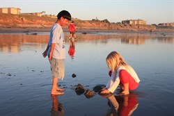 Kids playing in mud at San Simeon beach