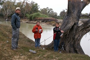 Some damp men fishing by the Cooper