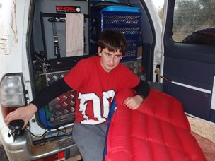 Riley preparing his bed for the evening and trying to stay dry.