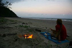 Campfire on the beach watching darkness approach