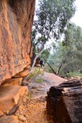 the track up the hillside between boulders around the edge of the walls