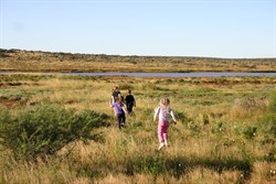 Kids running to the Lyndon River